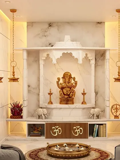 A luxurious pooja room designed with white marble, featuring a traditional arch and hanging brass lamps for a serene and opulent feel.