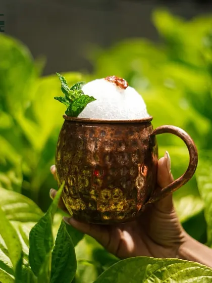 A refreshing cocktail in a copper mug, perfect for a warm day.