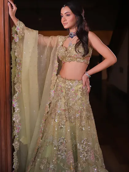 A soft, lime green lehenga with delicate floral embroidery. This look is perfect for a Mehendi ceremony or a summer wedding.