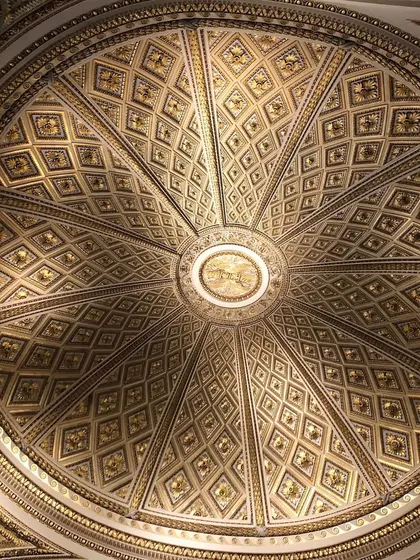 An ornate, gilded dome ceiling from a historic European building. The geometric precision and incredible detail are a testament to timeless craftsmanship. Architecture like this inspires me to bring a sense of history and grandeur into the spaces I design.