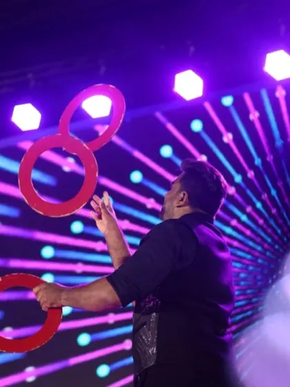 A stunning shot of our juggler in action, skillfully manipulating rings under vibrant stage lights. This act adds a touch of elegance and mesmerizing skill to any performance.