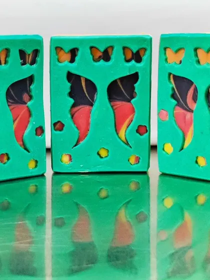 My "Butterfly Garden" soap, created for a peekaboo soap challenge using a soap dough sheet placed over a mantra swirl pour.