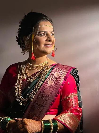 A profile shot showing the elegant bridal bun (Khopa) and the traditional jewellery that frames the face.