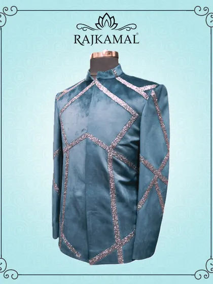 A teal blue velvet jacket with geometric sequin work. This is a bold and magical piece of groom's wear, perfect for a glamorous reception.