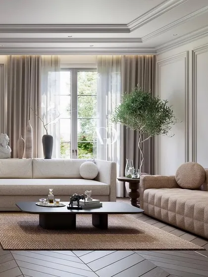 A close-up on one of the seating arrangements, showcasing the mix of a modern quilted sofa with a more traditional, soft-lined couch. The play of textures and forms adds visual interest.