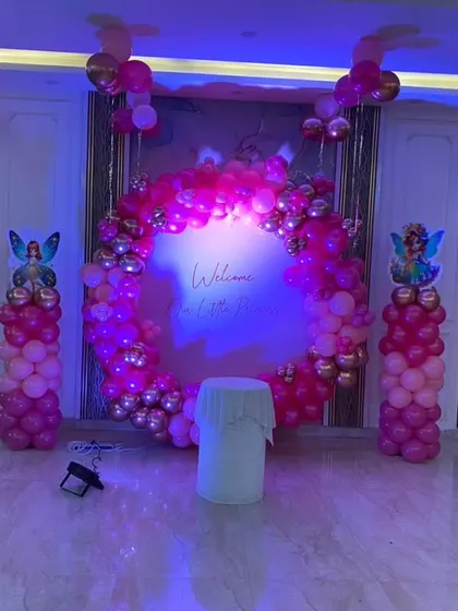 The princess welcome party setup illuminated with purple mood lighting. This shows how lighting can be used to change the ambiance and add a touch of magic to the decorations.