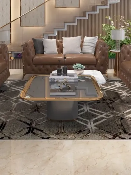 The main lounge area of the TATA Executive Floor, featuring classic tufted leather sofas and a custom geometric rug. The design creates a luxurious and comfortable environment for relaxation and informal meetings.