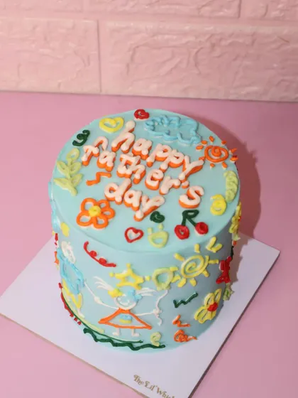 Another view of our colorful Father's Day doodle cake. We can turn your favorite childhood drawings into a cake he'll never forget.