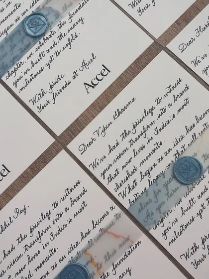 A little note of appreciation goes a long way. These notecards were hand-written for a private event for Accel, featuring classic black ink on white paper with a blue vellum band and a custom wax seal.