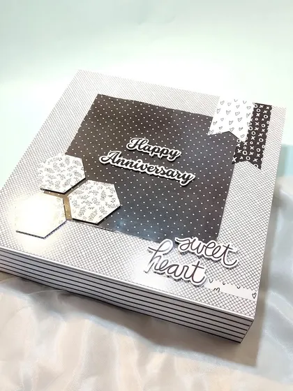 A sleek and modern anniversary scrapbook in a black and white theme. This design is perfect for a sophisticated and stylish couple.