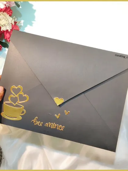 The elegant black and gold cover of the multi-envelope card.