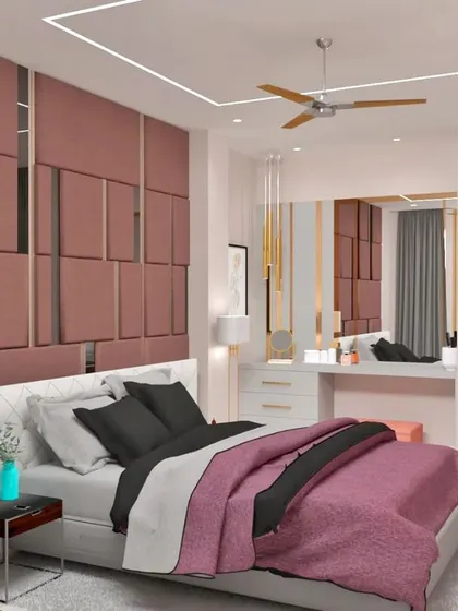 A luxurious bedroom design with a floor-to-ceiling upholstered accent wall in a dusty rose fabric. The geometric paneling with mirrored strips adds a touch of glamour.