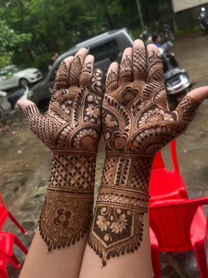 A clear shot of the completed bridal hands, showcasing the balance between dense patterns on the fingers and more open work on the palms.