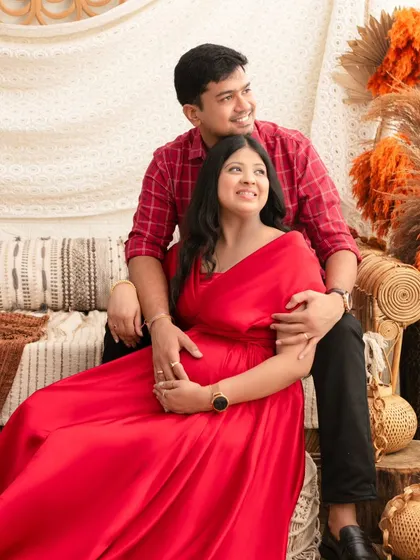 A joyful portrait of a couple looking forward to their future. Seated in our earthy, boho-themed set, their happiness is radiant.