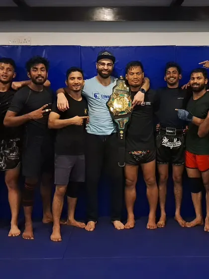 The team celebrating with Coach Chungreng after his monumental championship win. His work ethic is an inspiration to us all, showing up to teach class just two days after a grueling 4-round war.