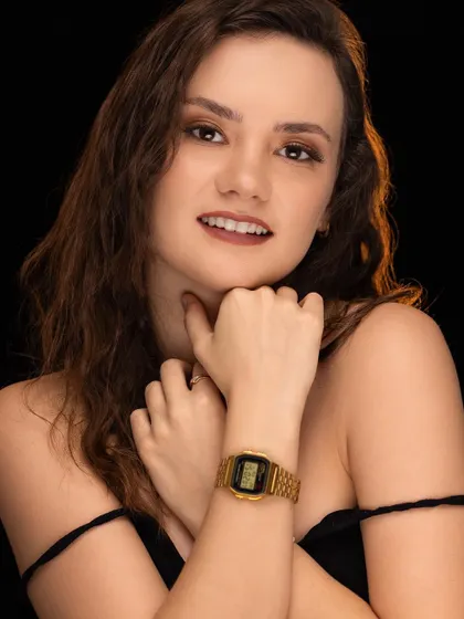A close-up beauty shot with warm, soft lighting against a black background. This type of image is perfect for showcasing makeup and the model's flawless features.