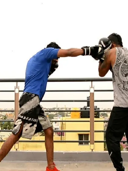 You fight how you practice. This photo captures a moment from a mid-range counter-attack drill on the rooftop. We are working on timing the perfect counter punch.