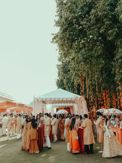 Guests mingling during an outdoor event at Rambagh Palace. I capture the lively ambiance and the joy of friends and family coming together.
