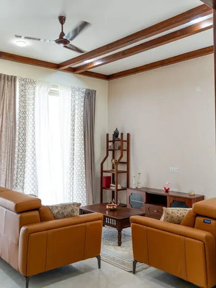 The full living room setup, with leather sofas and a complete set of our handcrafted wooden furniture.