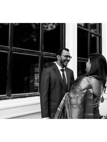 Laughter and love. This black and white candid shot captures a genuine moment of joy during a post-wedding session.