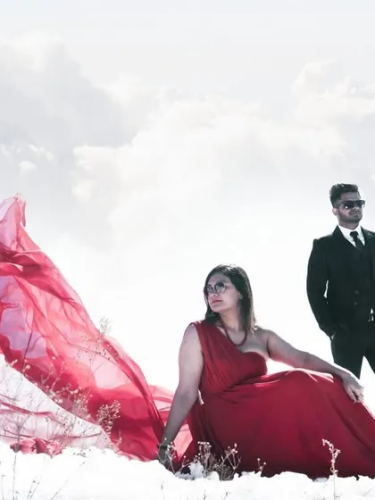 A highly stylized and dramatic portrait in the snow. This image showcases a more editorial approach, creating a high-fashion look that feels like it's straight out of a magazine while still telling their unique love story.