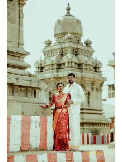 A stately portrait of the couple in front of a temple, a perfect blend of tradition and romance.