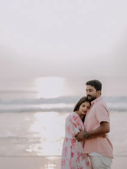 A gentle embrace during sunset on the beach. The soft, warm light of the golden hour creates a beautifully romantic and intimate atmosphere.