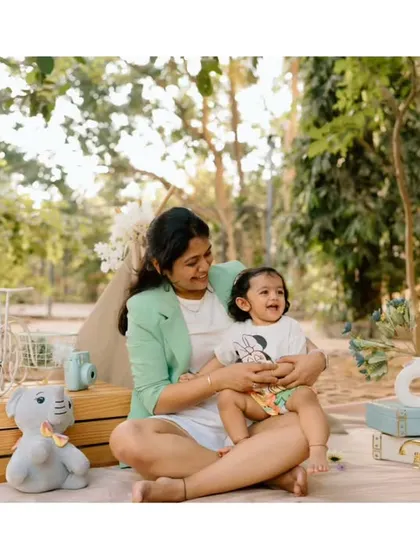 A mother and her little one enjoying a peaceful moment at their outdoor picnic. The love and happiness are so clear.