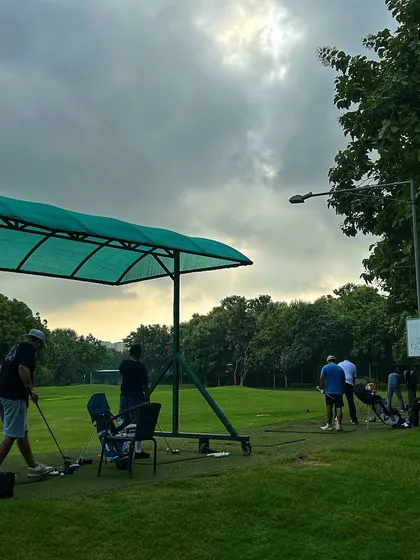 The dramatic sky over the driving range adds to the atmosphere of a weekend session.