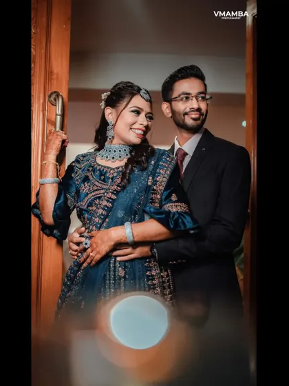 A stylish reception portrait of a couple, with a beautiful bokeh effect from the lights in the background.