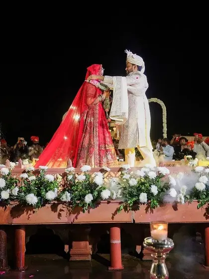 The couple exchanging garlands during the varmala ceremony.
