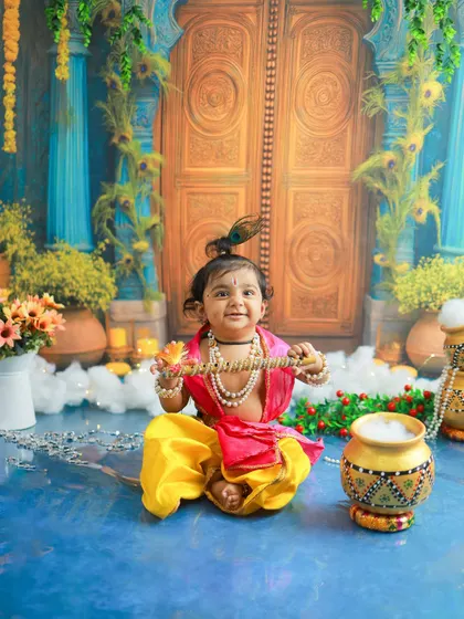 The dimples and the divine smile say it all. This close-up shot captures the pure, unadulterated joy of our little Kanha.