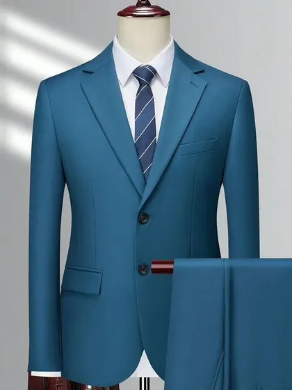 A two-piece suit in a vibrant teal color. It's a bold and confident look for the modern man.