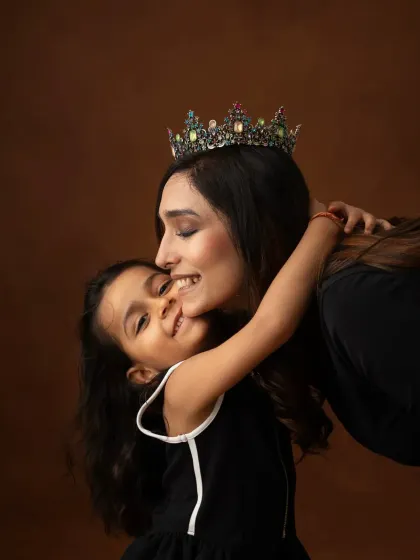 The sweetest embrace between a mother and her daughter. The crown adds a touch of royalty to this beautiful, moody portrait, celebrating the queen of the family.