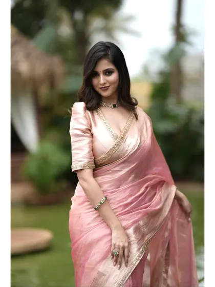 A three-quarter shot of the pink tissue silk saree, exuding timeless elegance.
