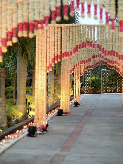 A beautiful floral pathway made of jasmine and rose arches, creating a romantic tunnel for guests to walk through.