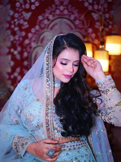 The veil shot! A classic bridal portrait is made even more beautiful with the sheer, embroidered dupatta of this lehenga.