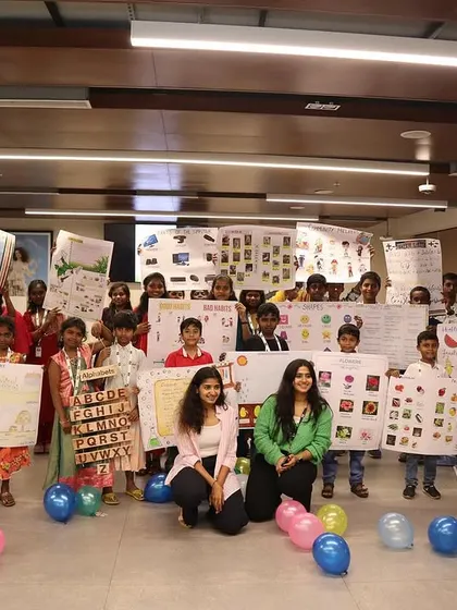 The full group from the Hudson's Bay workshop, holding up charts and art they created. It was a day of learning and creativity.
