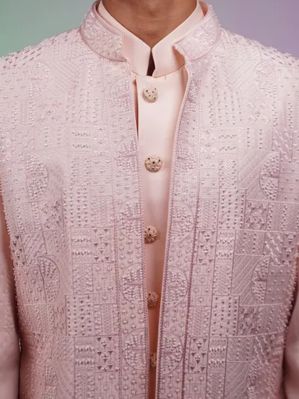 A close-up of the embroidery on the pink Indo-western jacket. The tone-on-tone work is subtle yet sophisticated.
