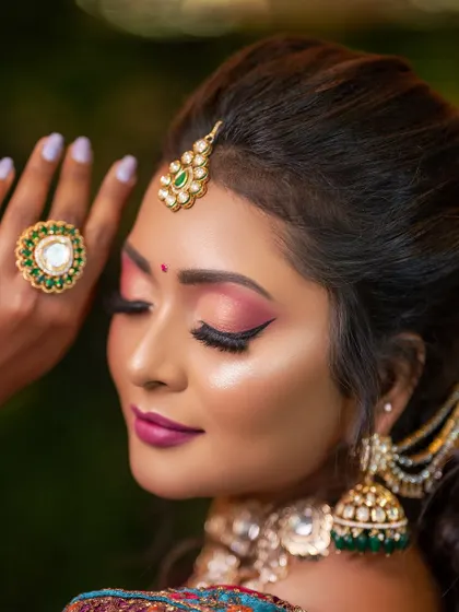 A detailed shot of the eye makeup for the reception look, featuring a blend of pink and shimmer with a sharp wing.