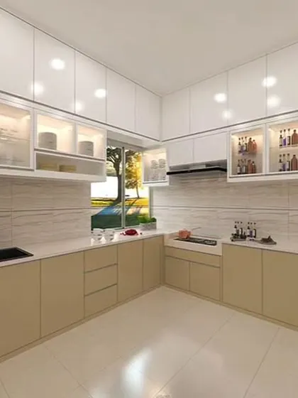 This bright L-shaped kitchen uses a combination of solid and glass-front upper cabinets with internal lighting. The beige lower cabinets and light tiled floor contribute to the spacious and airy atmosphere.