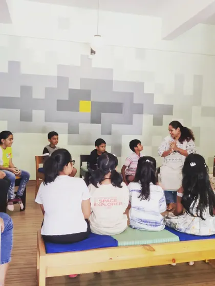 A view from the back of the room, showing the group completely focused on the storyteller. We work hard to command the room with just the power of a good story.