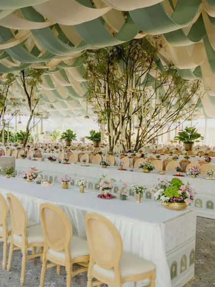 A wedding is a tapestry of cultural stories. For this South Indian wedding, we designed an authentic Sadhya lunch experience within a custom-built glass hangar. The decor, from the draped fabric ceiling to the floral arrangements and traditional brassware, was meticulously planned to honor the sanctity and communal joy of the feast.