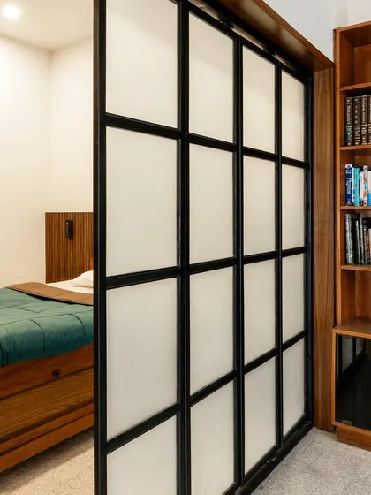 This before-and-after sequence shows how we reimagined a large, cluttered bedroom. By introducing a sliding partition and custom joinery, we created a multi-functional master suite with a cozy sleeping area, a wardrobe, and a bright study space, optimizing every inch of the room.