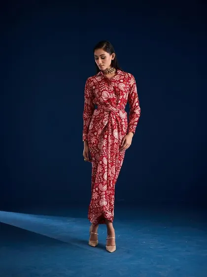 A three-quarter view of the Aapro Rosela Draped Skirt Set, capturing a thoughtful and elegant pose.