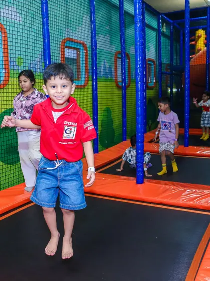 A boy mid-jump on the trampoline, taking full advantage of our Summer Fun Pass.