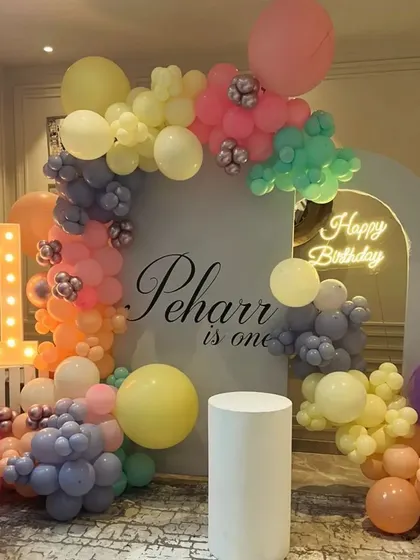 We love creating personalized setups, like this one for Peharr's first birthday. The pastel balloon arch, custom backdrop, and light-up number '1' came together to create a soft and dreamy atmosphere for this special milestone.