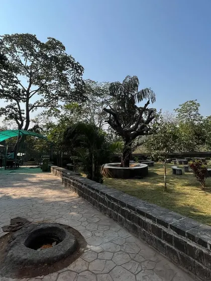 The peaceful, green pathway and rest area for visitors within the Kanheri Caves complex.