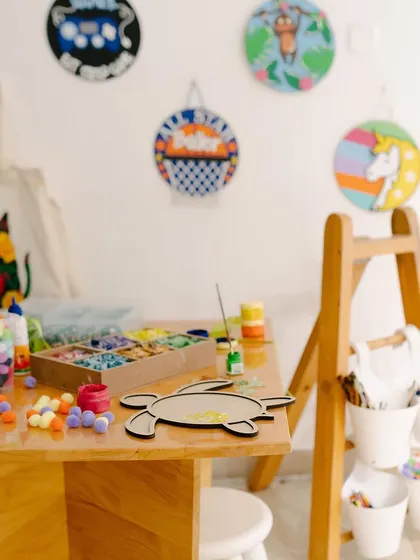 Our craft table is always ready for action, stocked with colorful pom-poms, mosaic tiles, and everything else you need to get started on a fun DIY project.