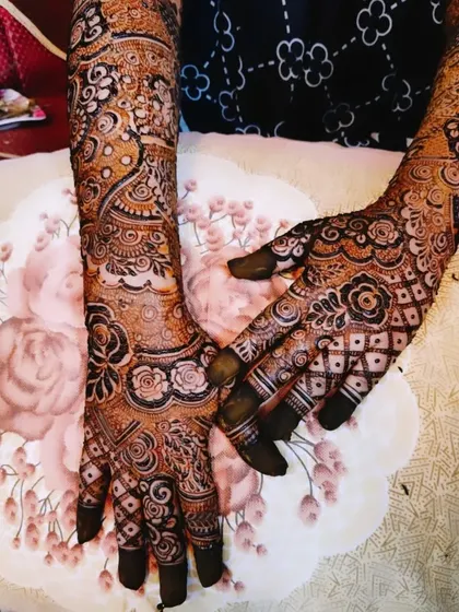 Farheen's bridal mehndi, featuring a mix of bold floral work and intricate checkerboard patterns.